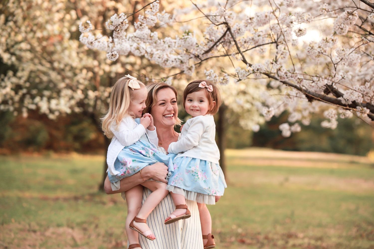 fine art family outdoor portrait of mommy and me under cherry blossoms