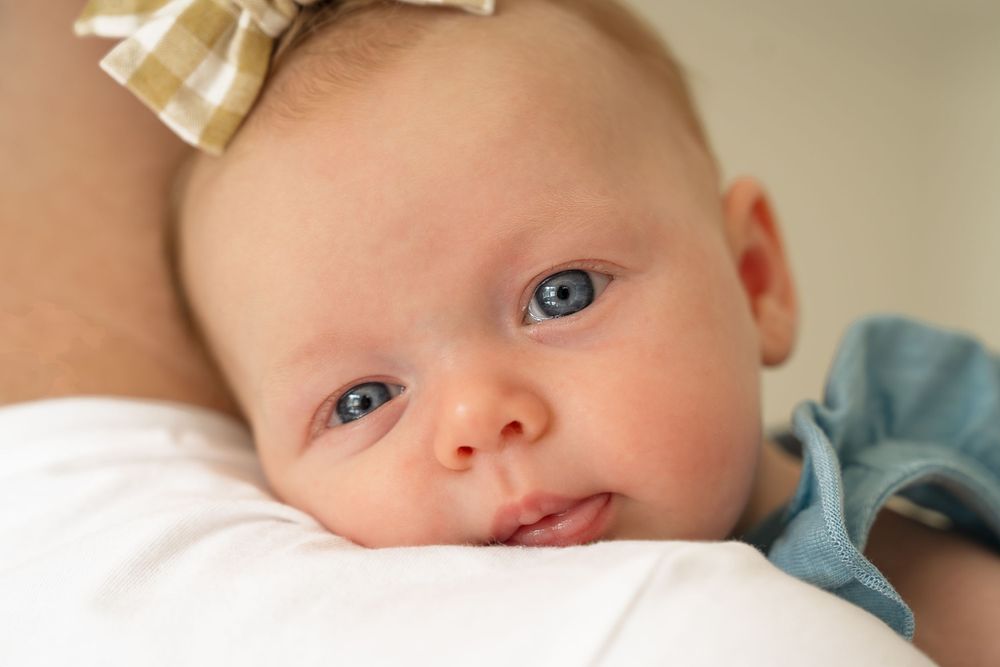 In home portrait session San Antonio Texas baby girl looking at camera