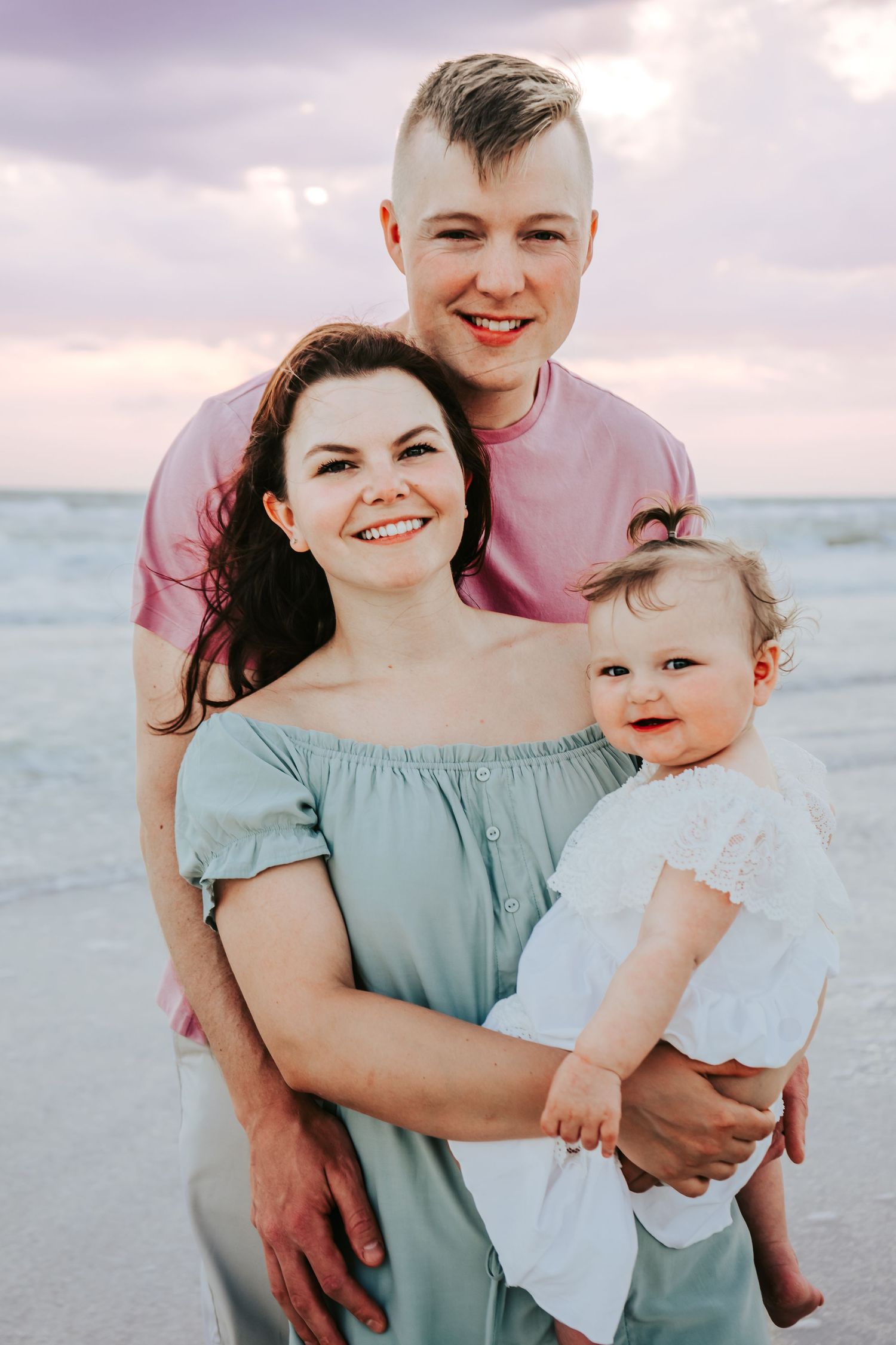 Outdoor Family Session at Indian Rocks Beach in Indian Rocks, FL; family posing together on beach at sunset