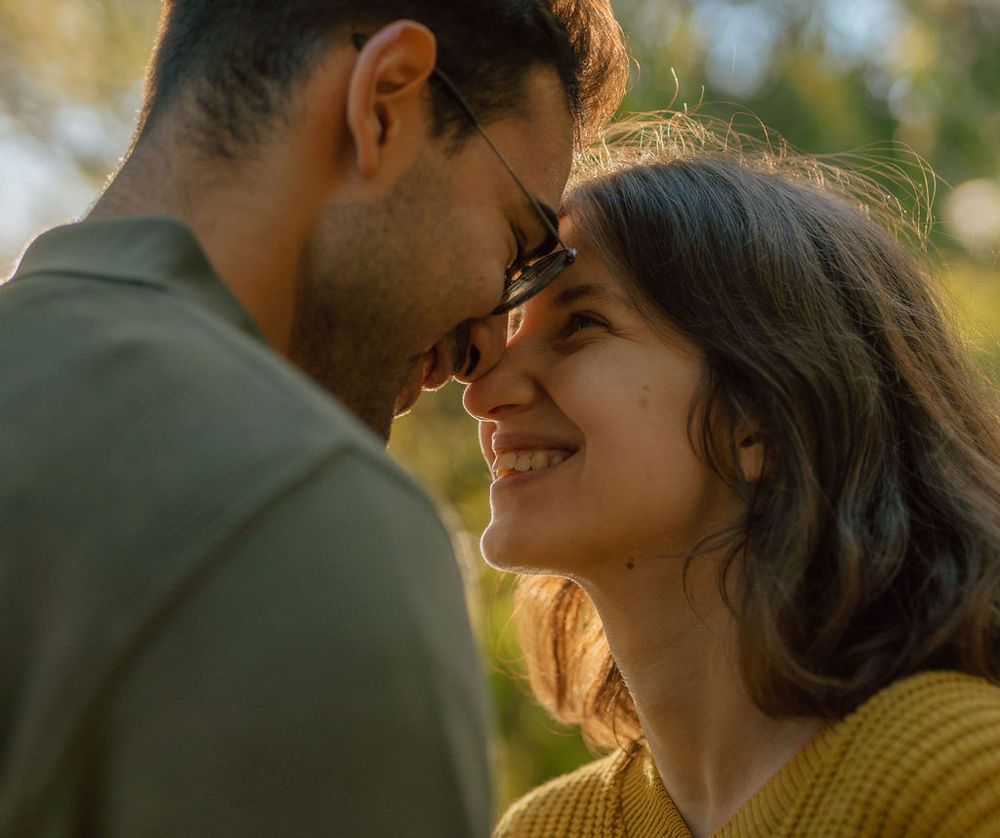 Intimate moment between couple in warm autumn light.
