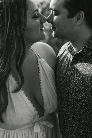 Intimate black and white portrait of couple about to kiss.