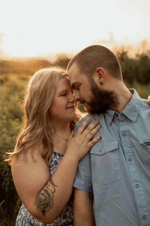 Romantic close-up portrait of couple sharing intimate moment in golden sunlight.