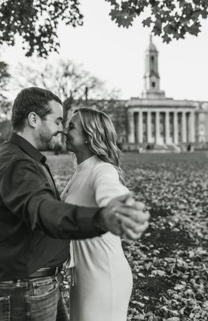 Romantic black and white portrait with historic university building in background.