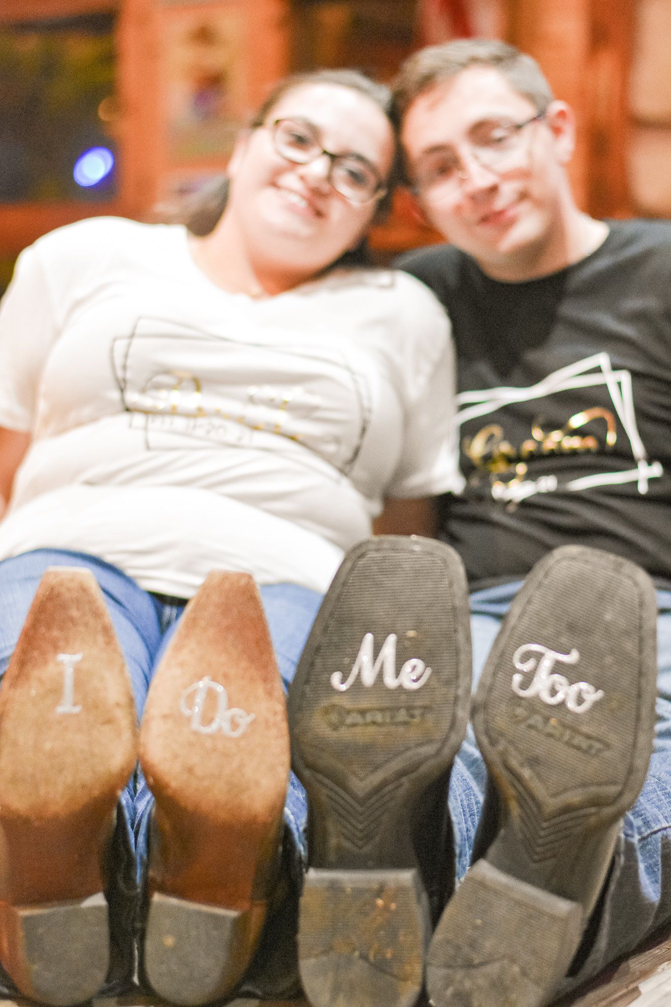 Boots with 'I Do' and 'Me Too' written on soles creating cute wedding detail shot.