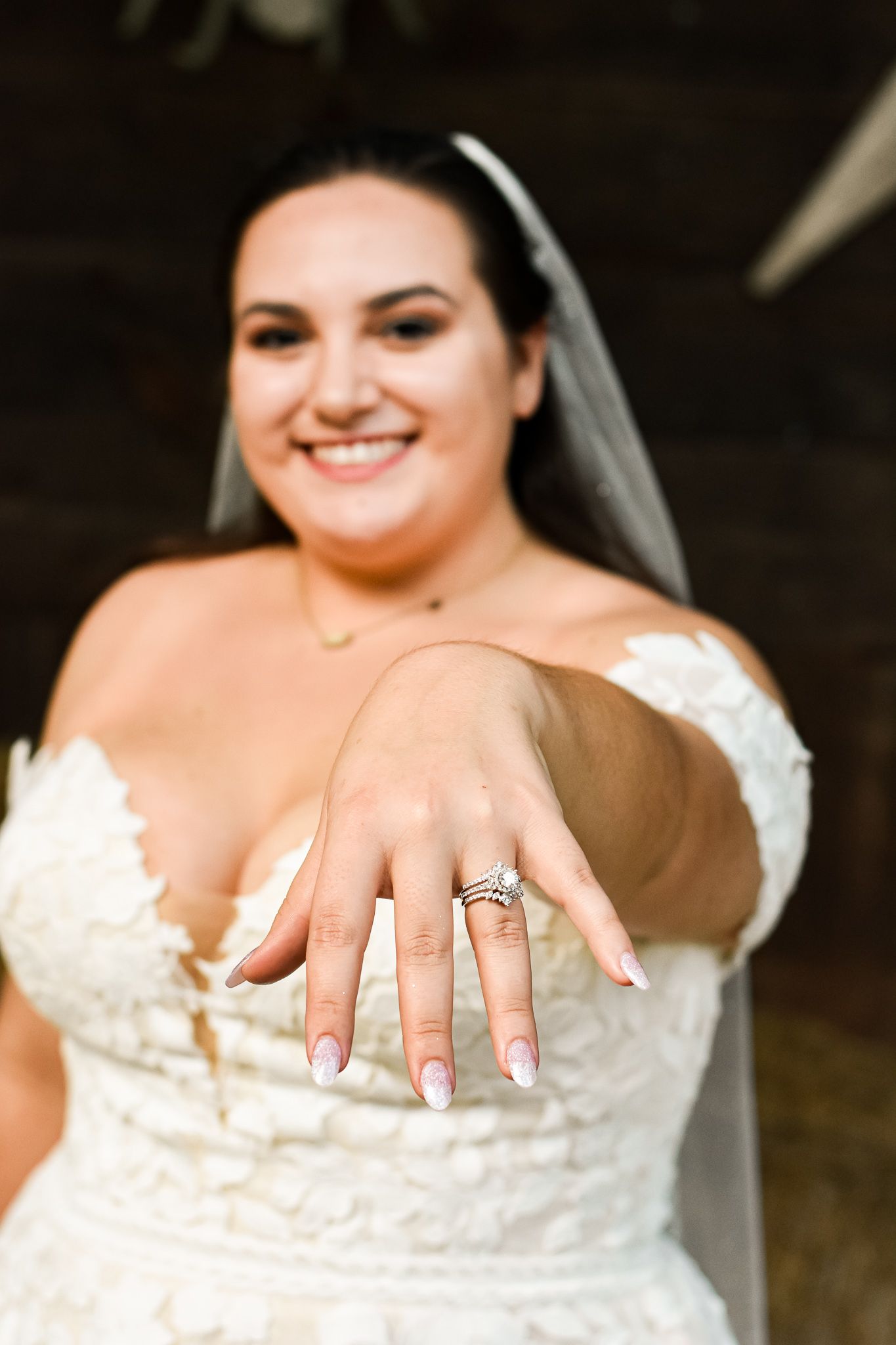 Close up of engagement ring and manicured nails on wedding day.