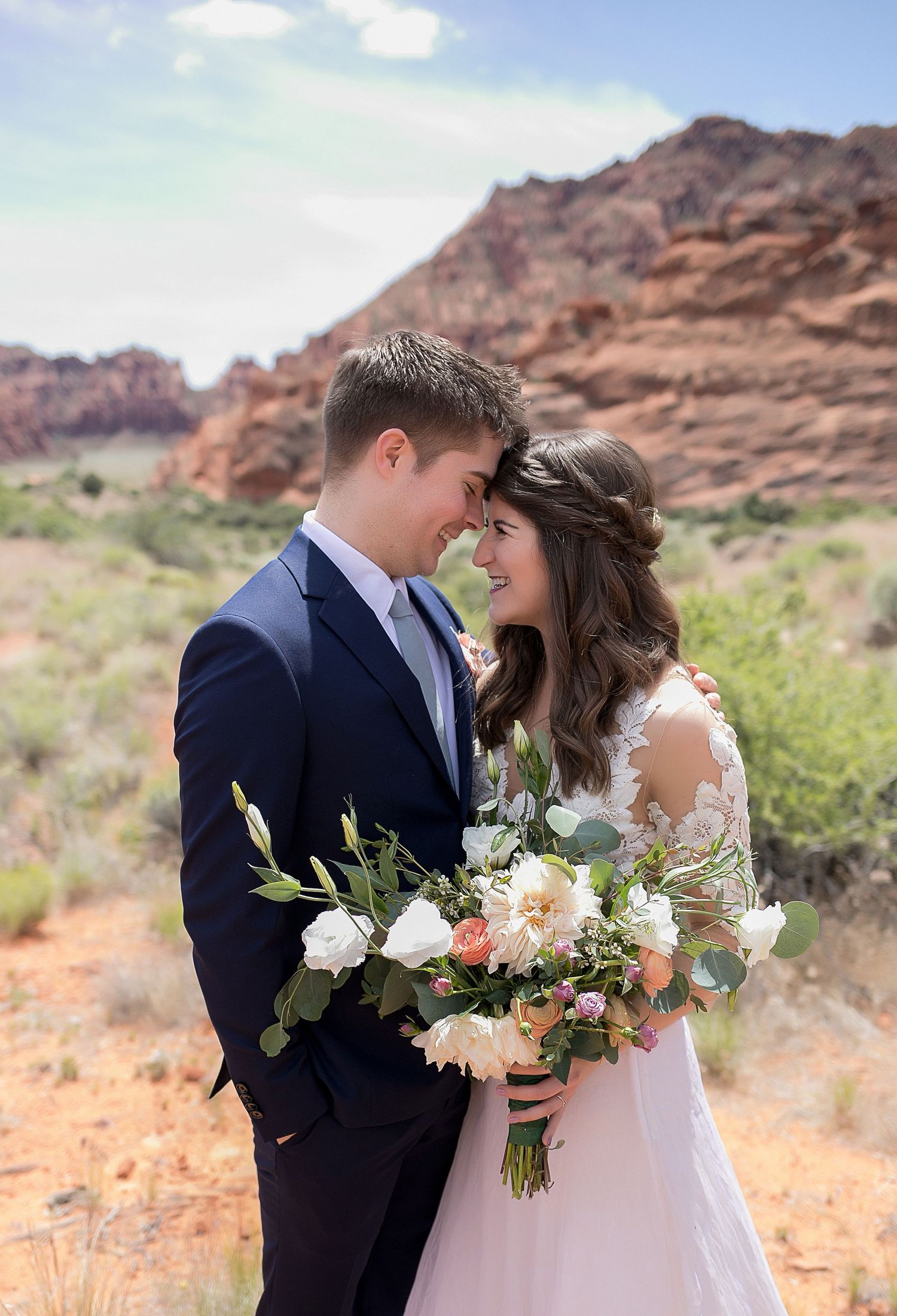 Bride and group with wild flower bouquet at Snow Canyon State Park, Utah destination wedding