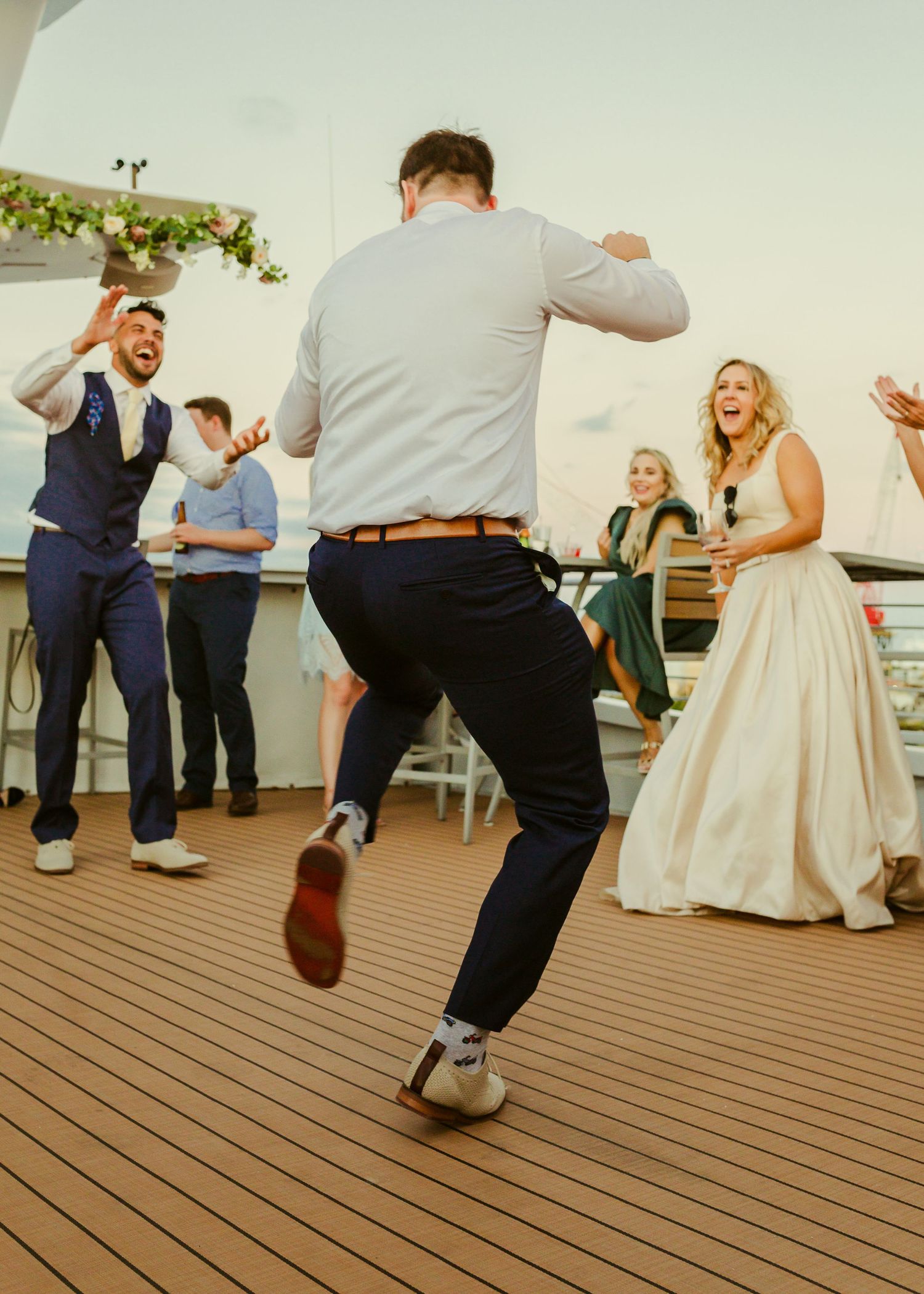 the bride and groom watching thier guest dance off