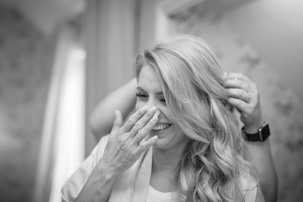 A black and white candid portrait showing genuine emotion and joy.