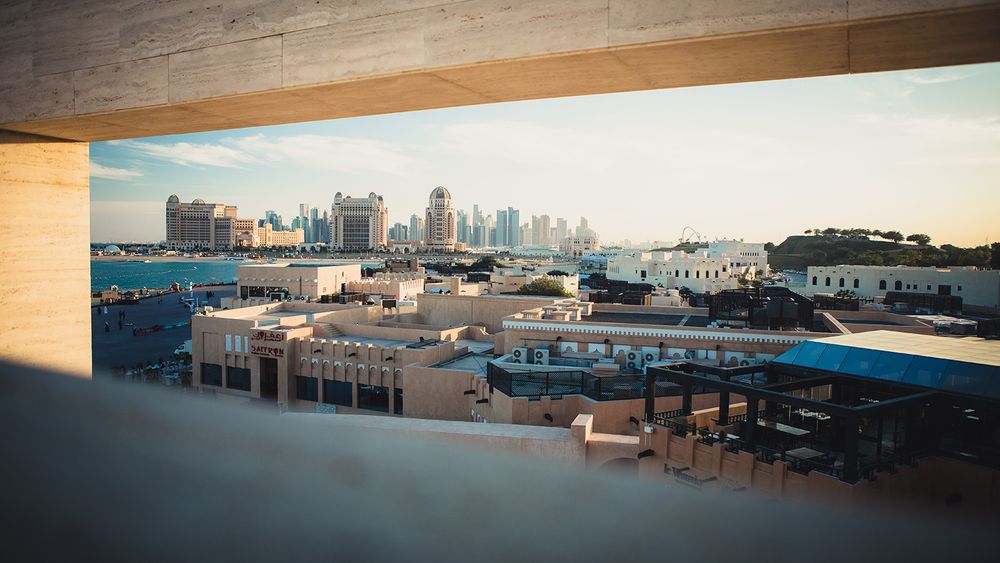 Modern cityscape with highrise buildings viewed through an urban framework.