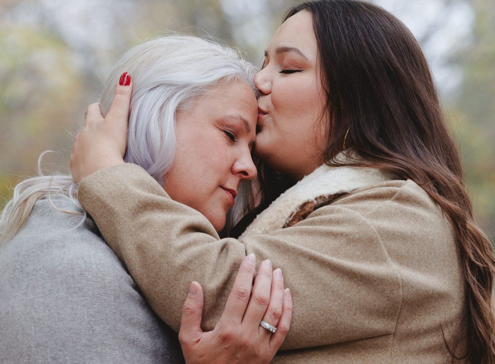 Two people share an intimate emotional moment outdoors.