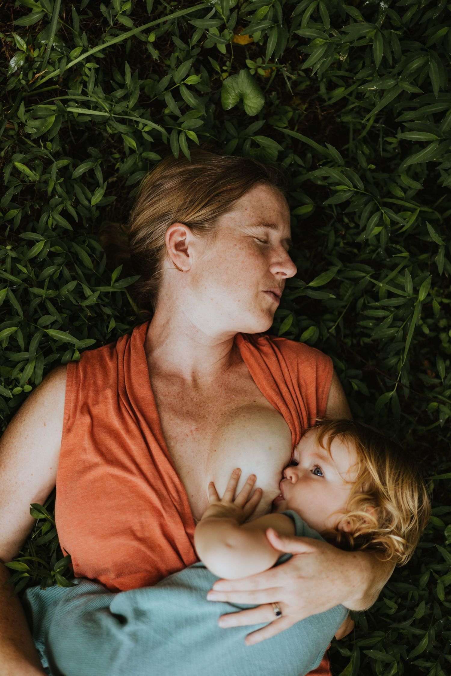 mother in grass nursing child