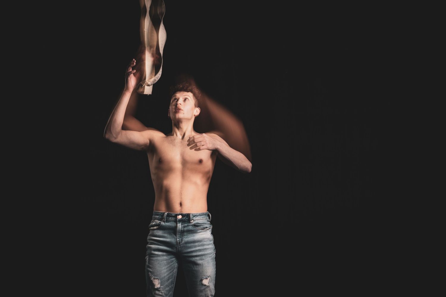 performance photography of a circus performer wearing jeans and no top