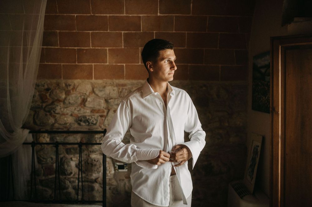 Wedding preparation scene in stone villa room with warm lighting.