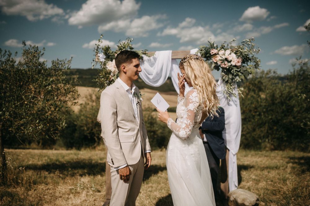 A joyful moment between newlyweds during their countryside wedding ceremony.
