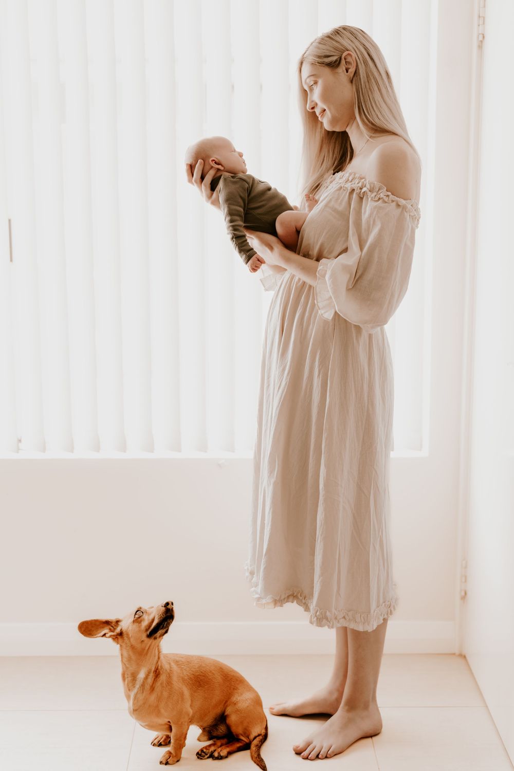 A serene nursery scene with a small dog watching from below.
