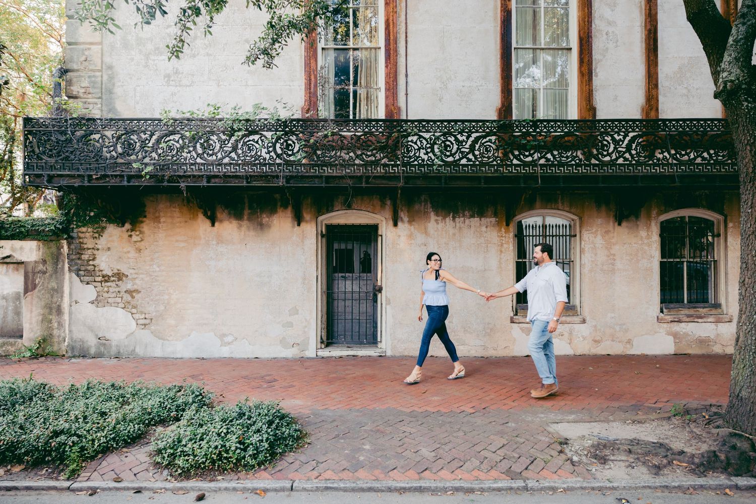 Couple walking looking at each other in Savannah, GA