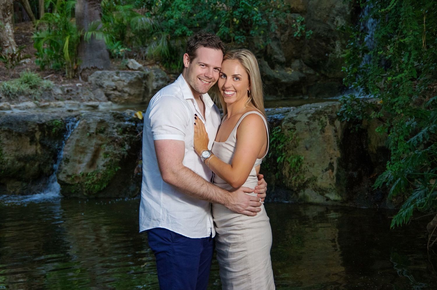 couple embracing infront of waterfall