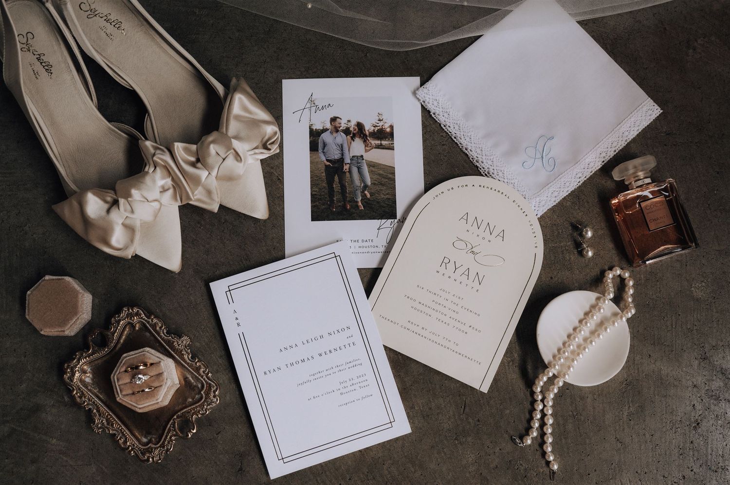 Wedding accessories and invitations artfully arranged with vintage details.