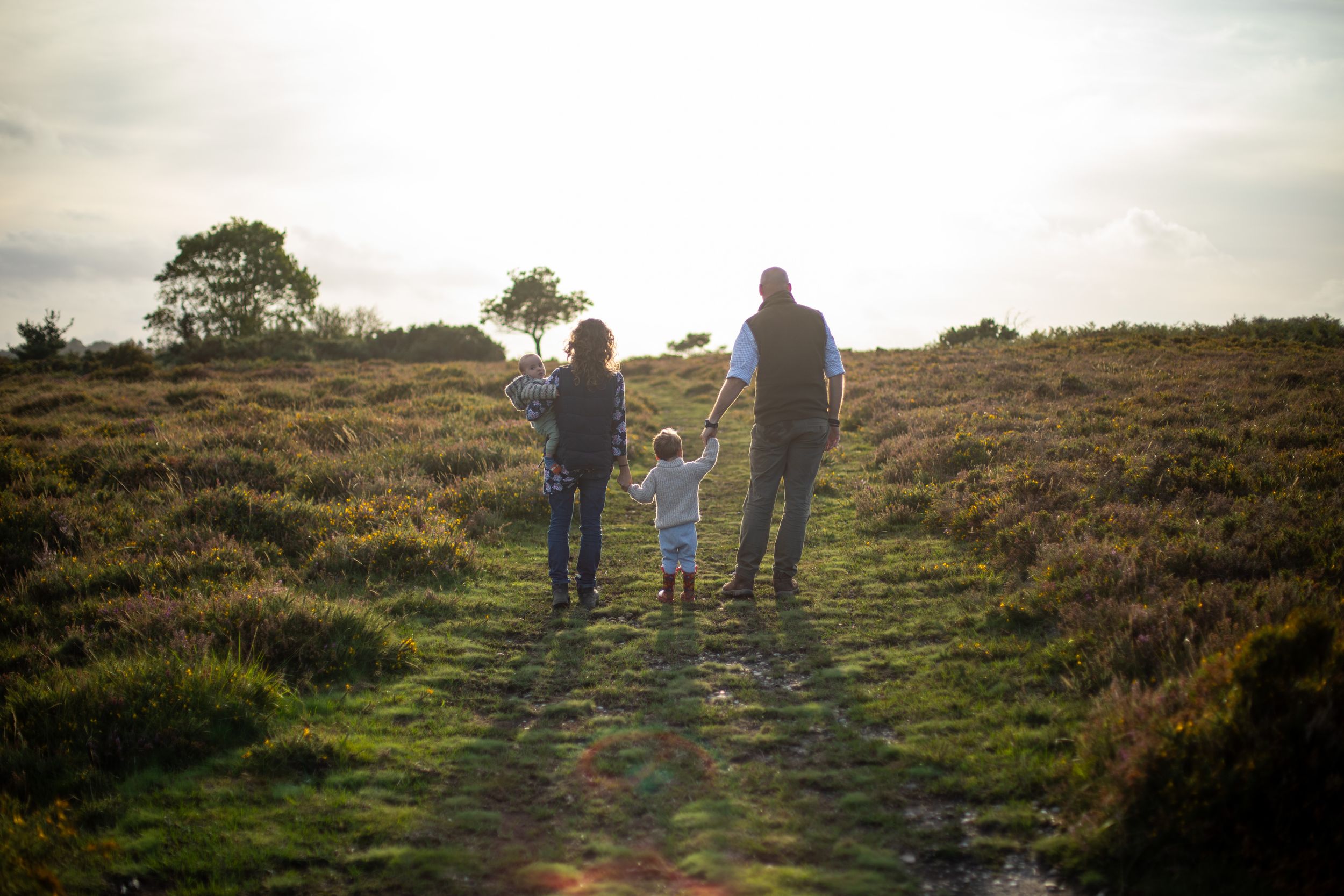 Candid photo of family walking, Aylesbeare Common, Devon