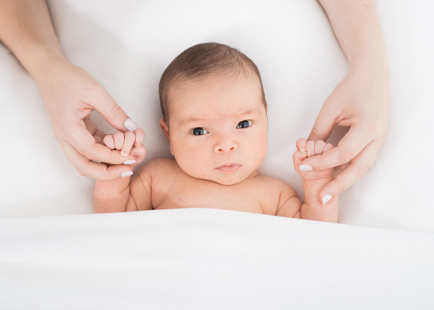 newborn baby girl looking at the camera during an newborn studio session in houston