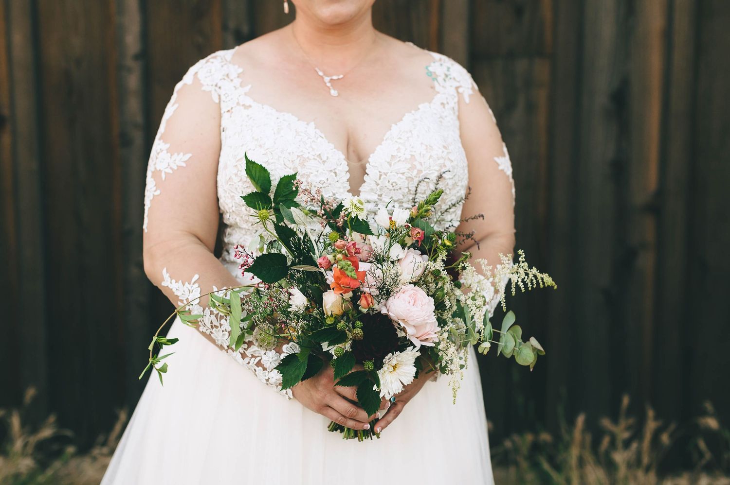 Close up of pastel color bouquet being held by the bride.