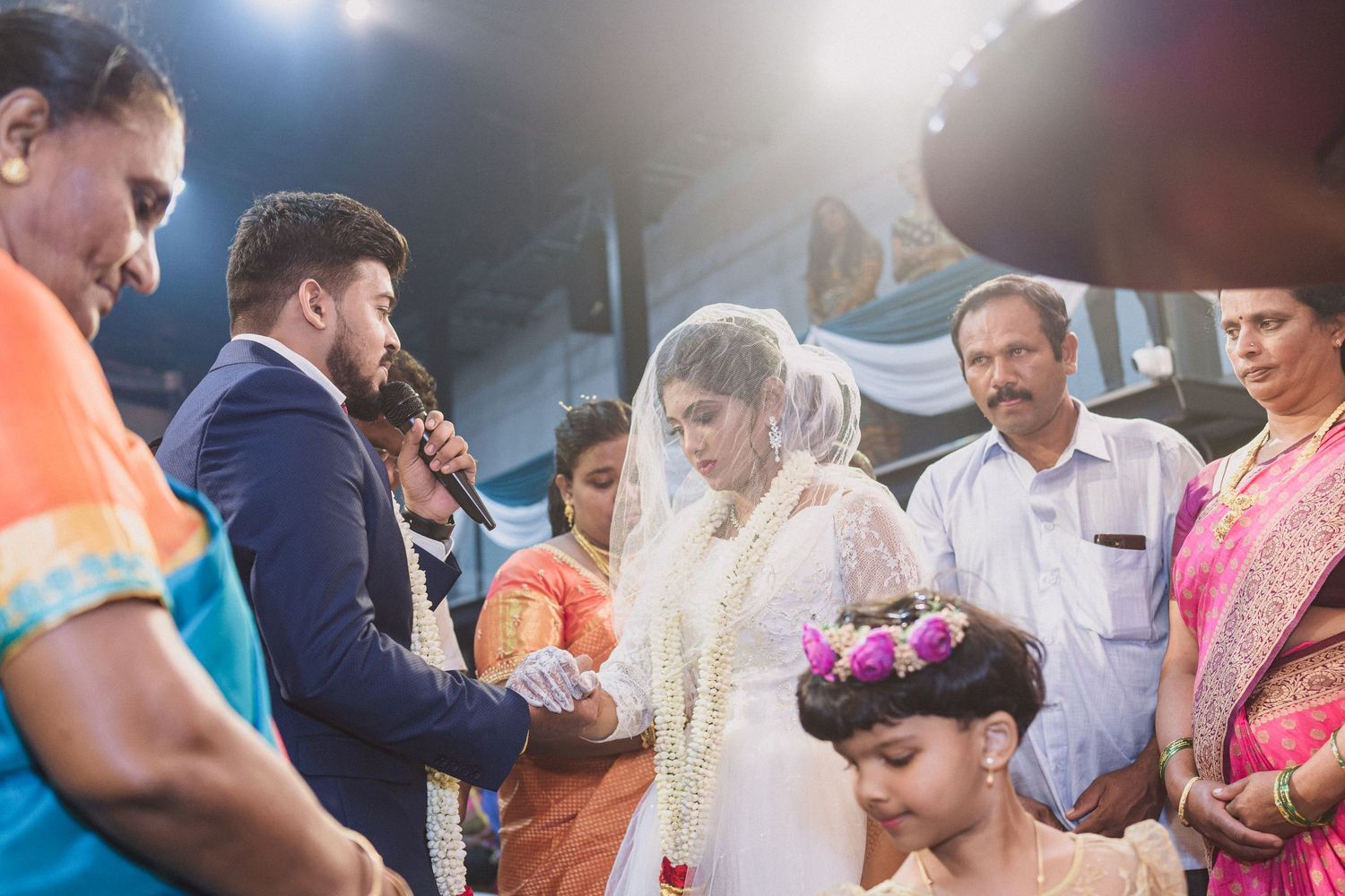 Wedding celebration with guests gathering around the couple during a traditional ceremony.