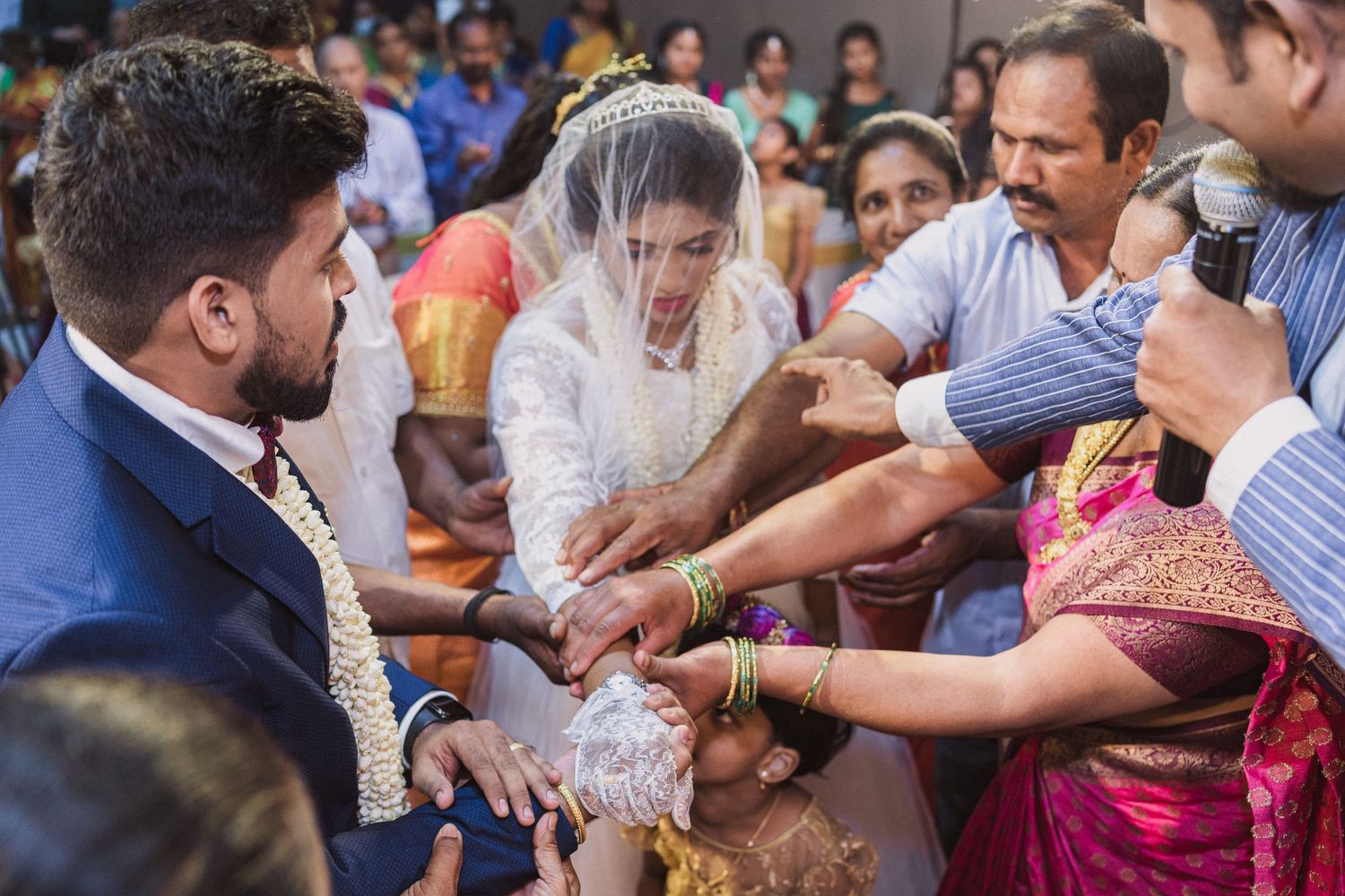 Wedding ritual involving multiple participants exchanging or blessing items during ceremony.