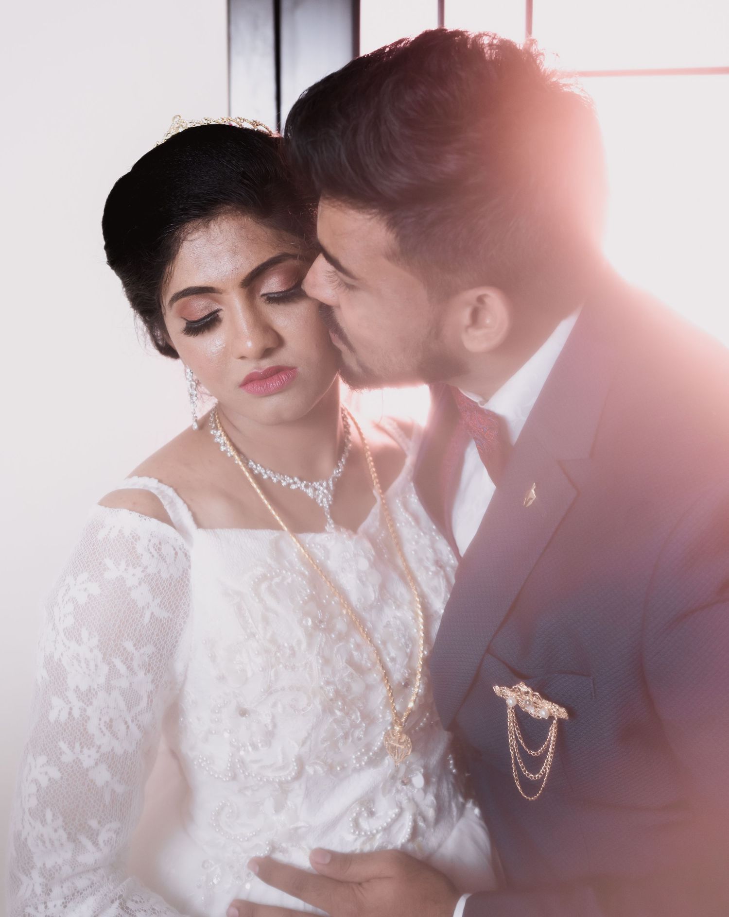 Intimate romantic portrait of newlyweds in classic wedding attire.