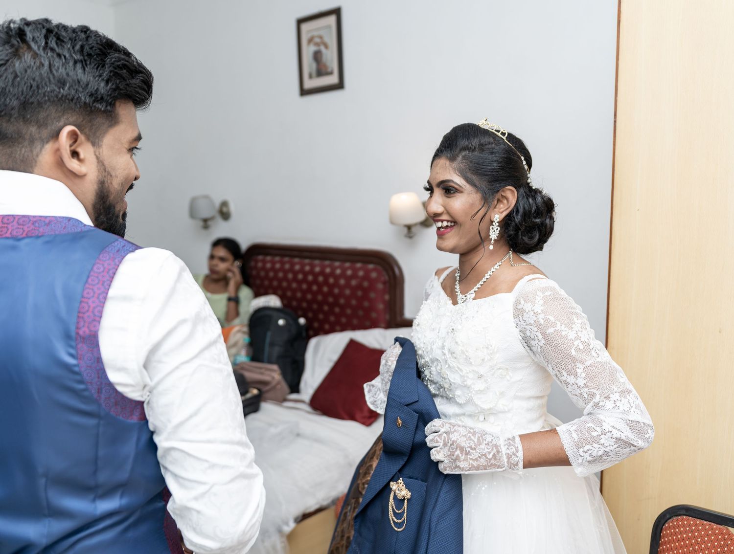 A couple sharing a joyful moment while getting ready for their wedding.