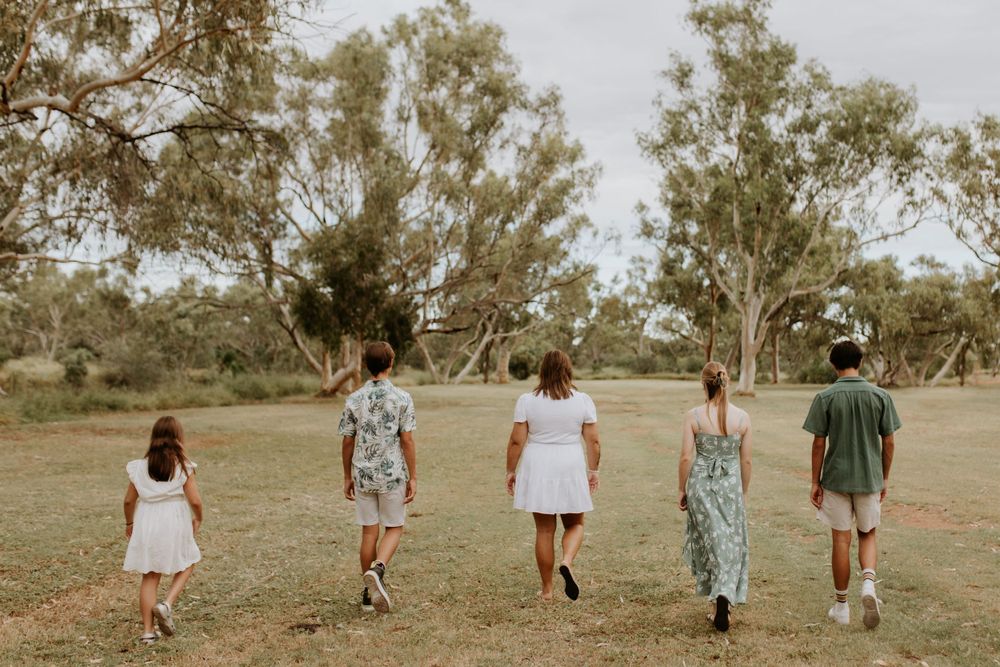 family of 5 walking through the park