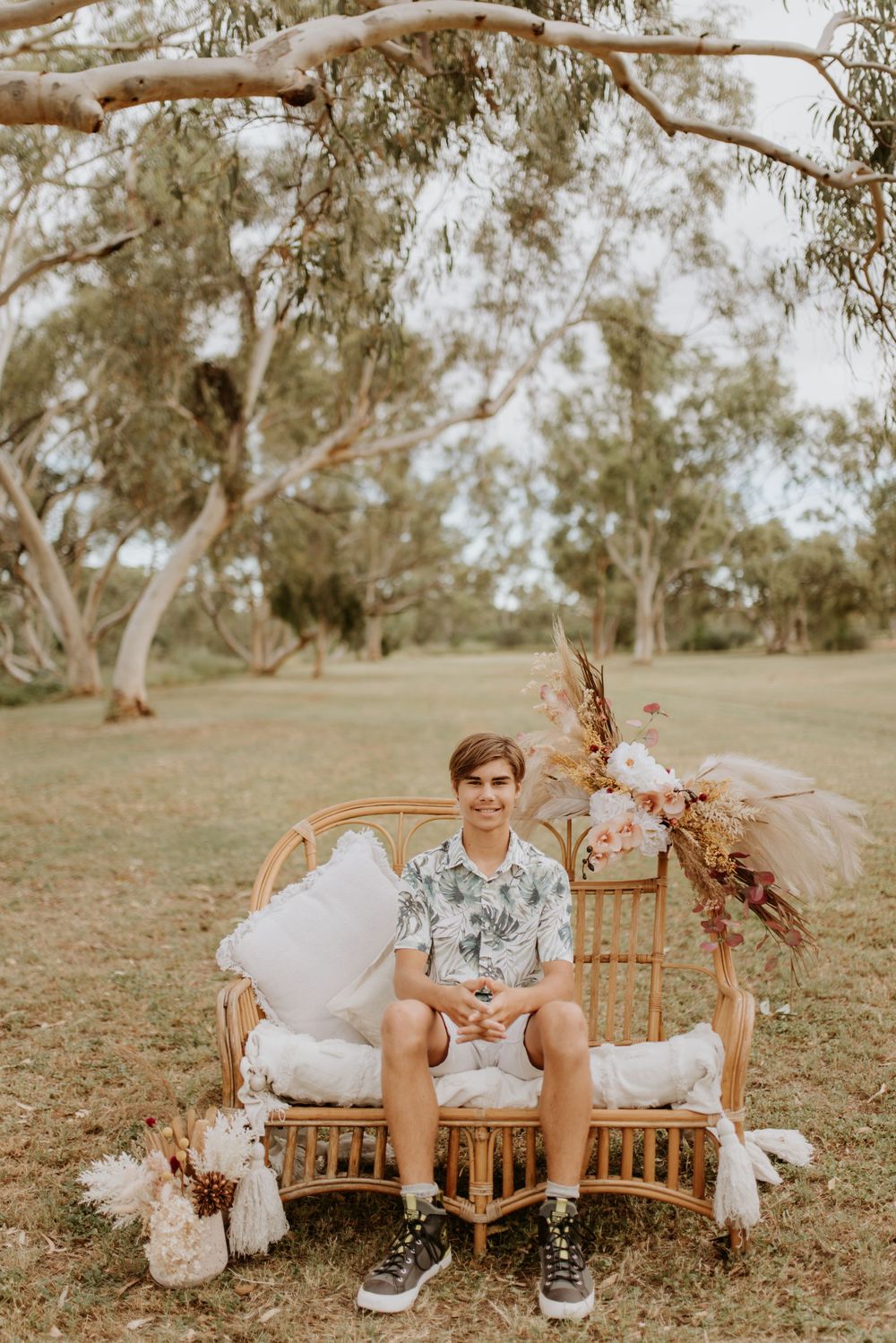 self portrait on young man sitting on cane chair in the park in mount isa