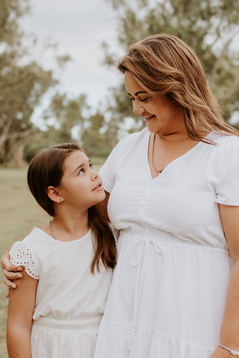 young daughter looking up into mothers eyes