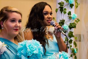 Event portrait of two people in formal attire with turquoise decorations.