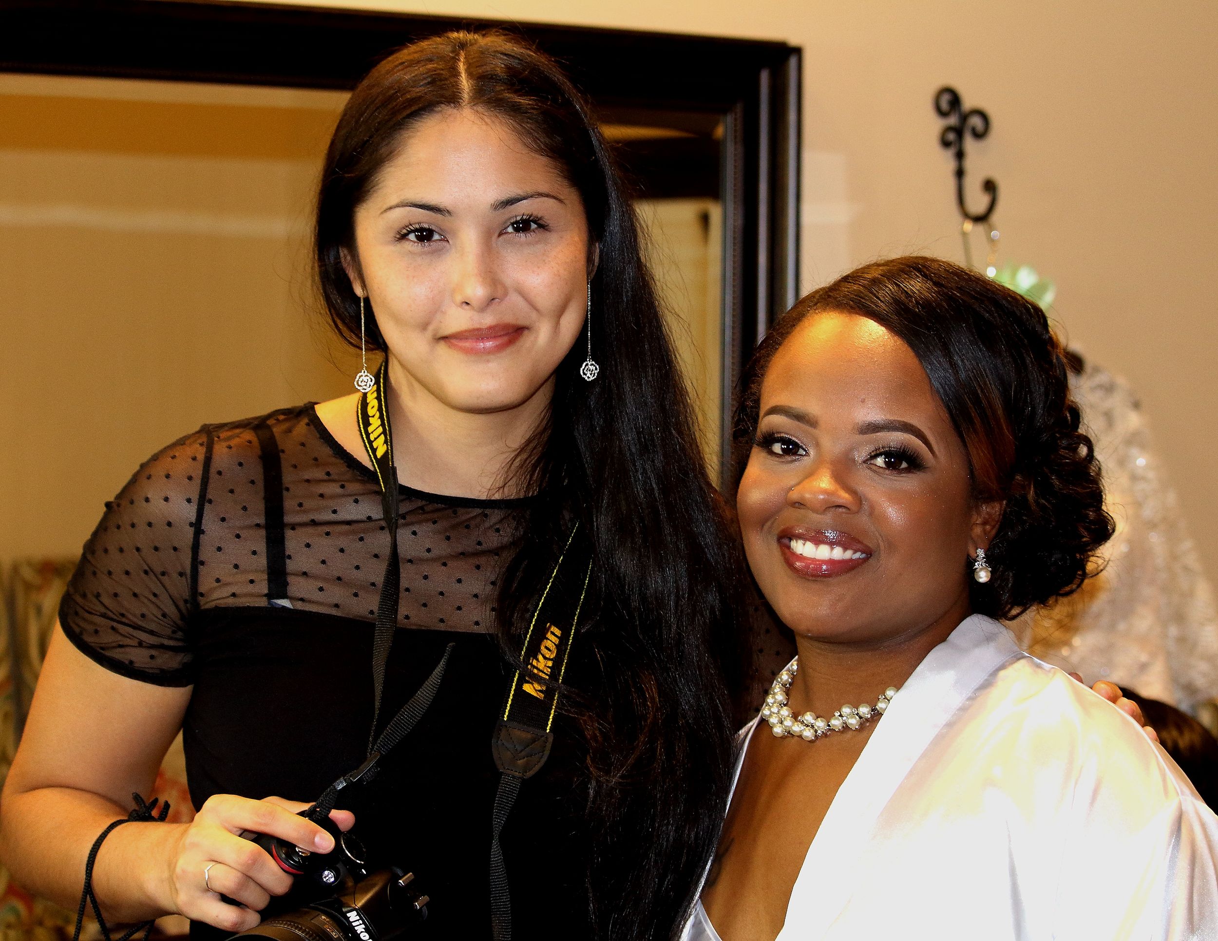 Two people smile at formal event with elegant attire and jewelry.