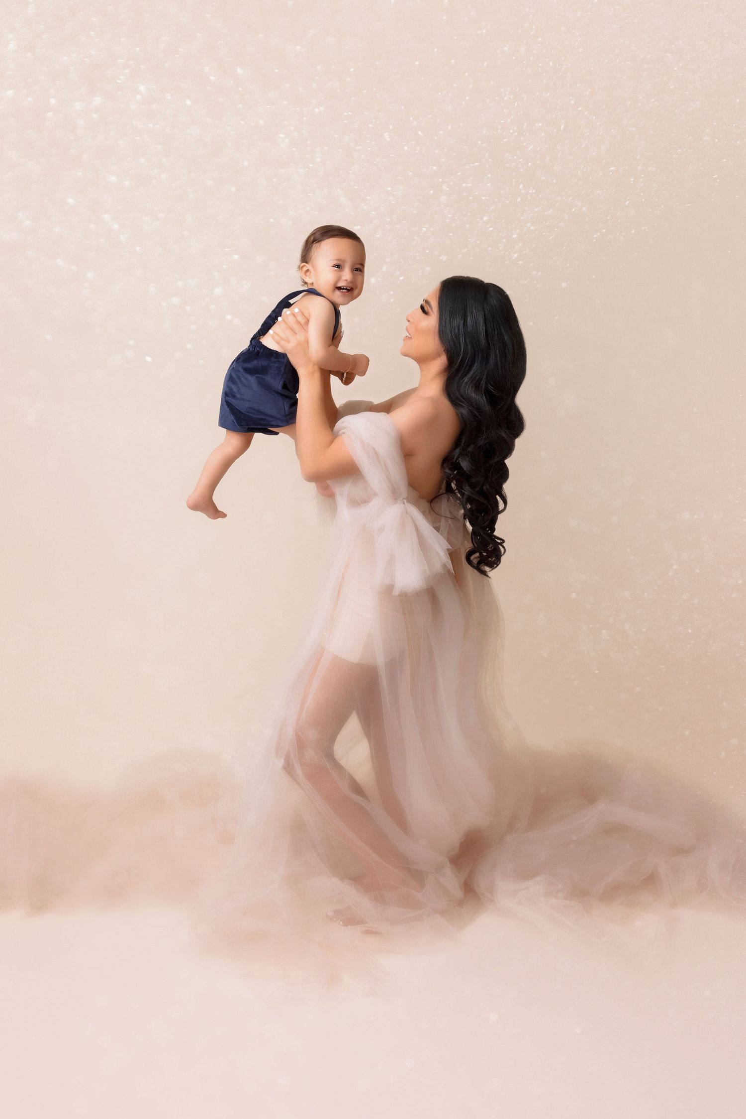 Artistic portrait in soft pink tones featuring flowing sheer fabric and natural movement.