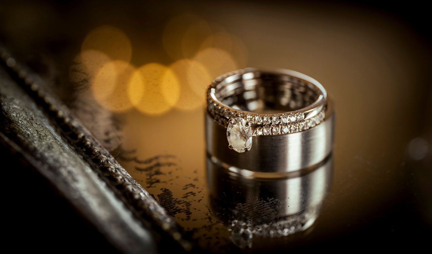 capturning the finer details of a wedding the rings placed artistically vintage bokeh