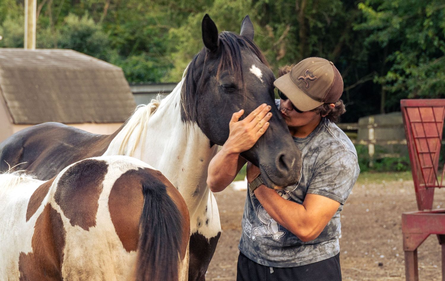 Man with Paint horse kissing horses nose
