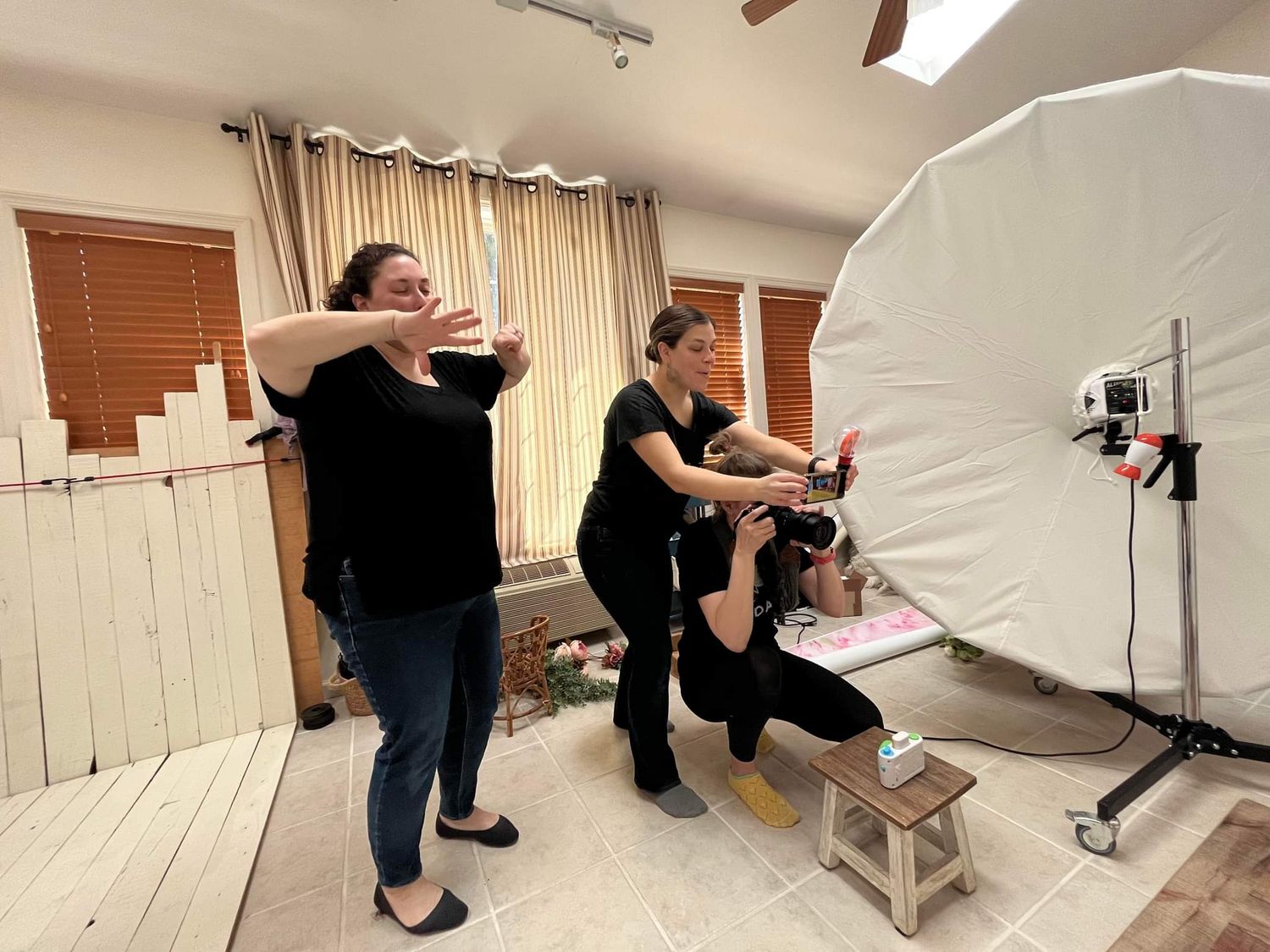 Photography studio setup with lighting equipment and reflectors in an indoor space.