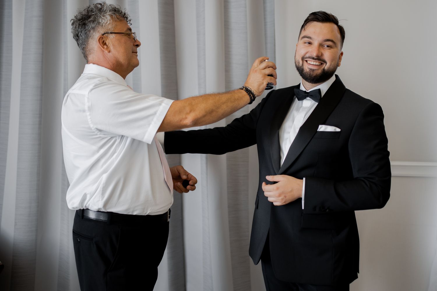 Final adjustments being made to formal attire before an event.