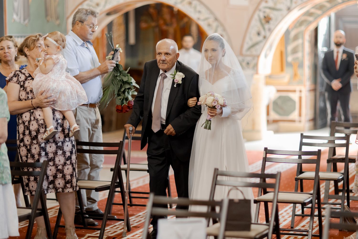 A traditional church wedding ceremony with elegant architectural details and gathered guests.