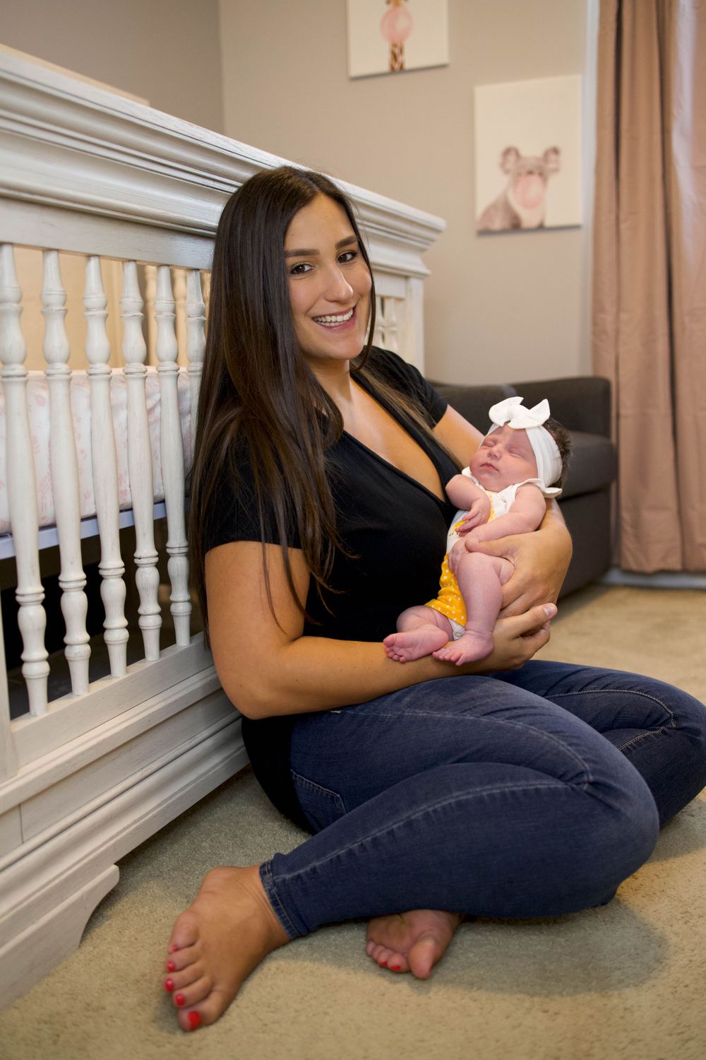 Mom sits with her newborn in nursery