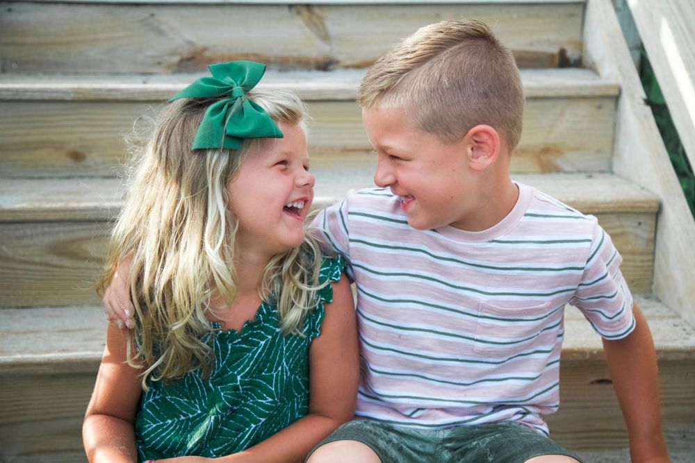 Sibling laughing together on stairs