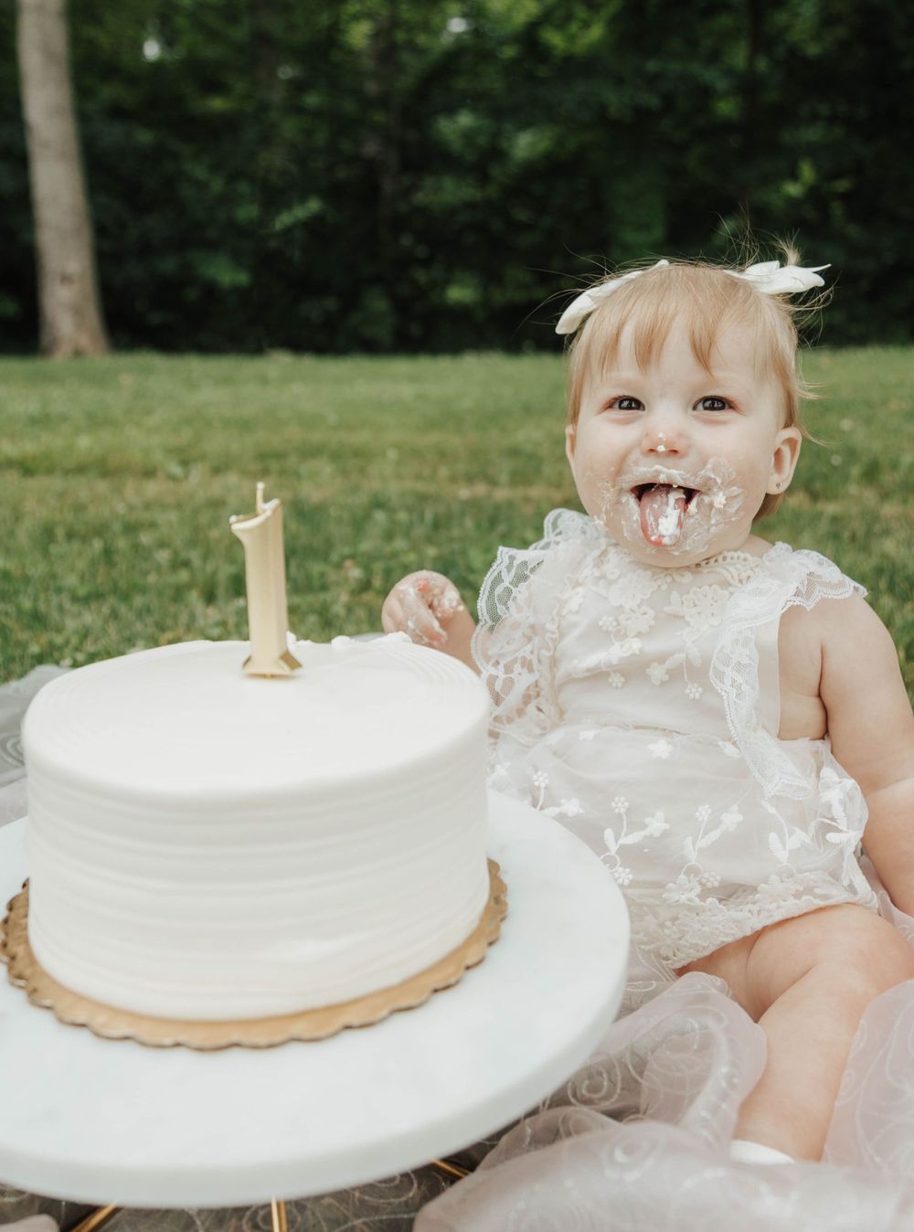 Happy baby smashing birthday cake with hands and face