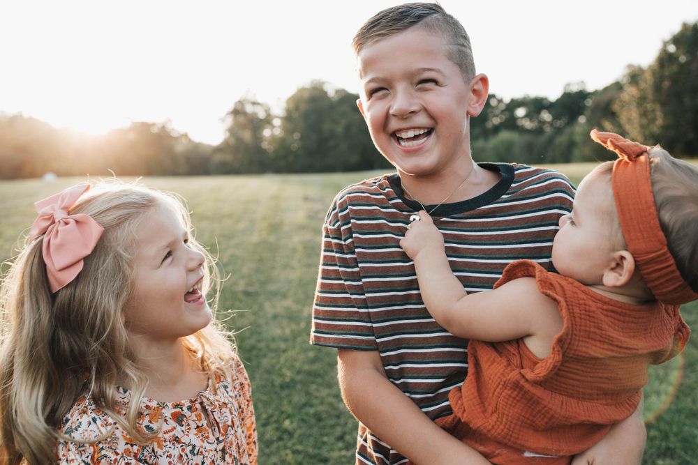 Siblings laughing at golden hour