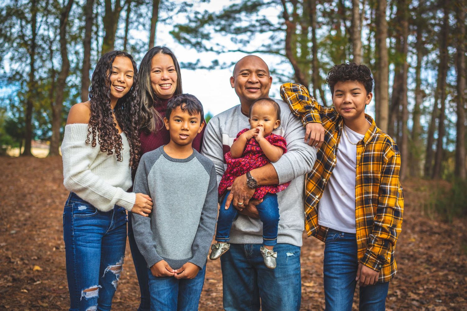 father ,mother, teen daughter, two boys and baby girl