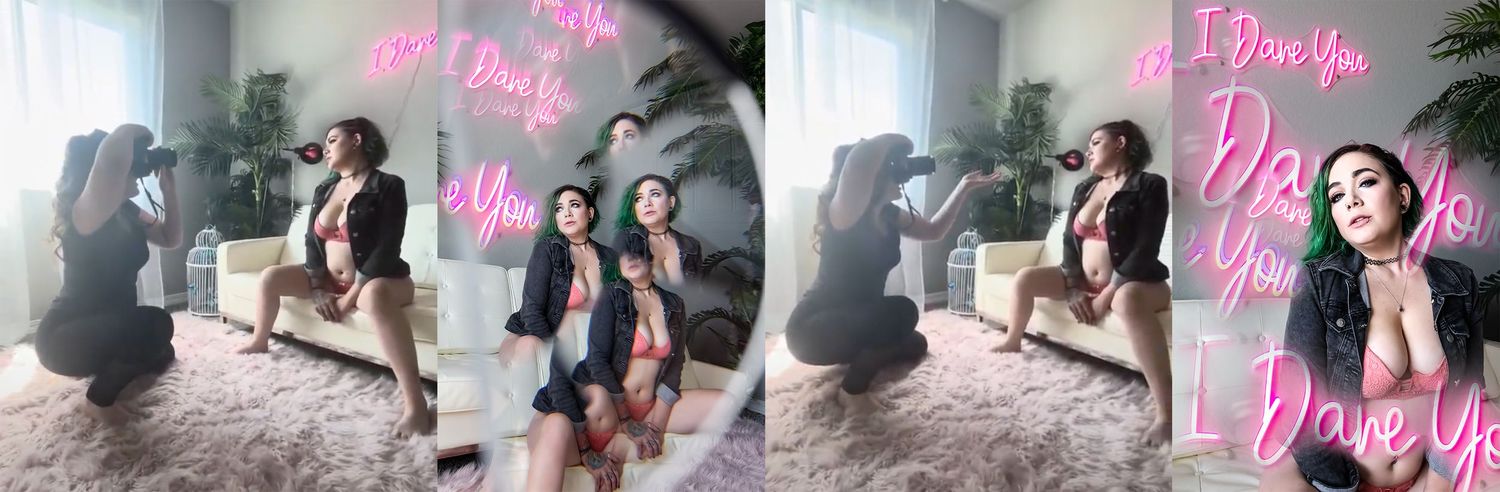 Colorado Springs Boudoir Photographer taking pics of client & showing after images, woman in pink lingerie & neon sign