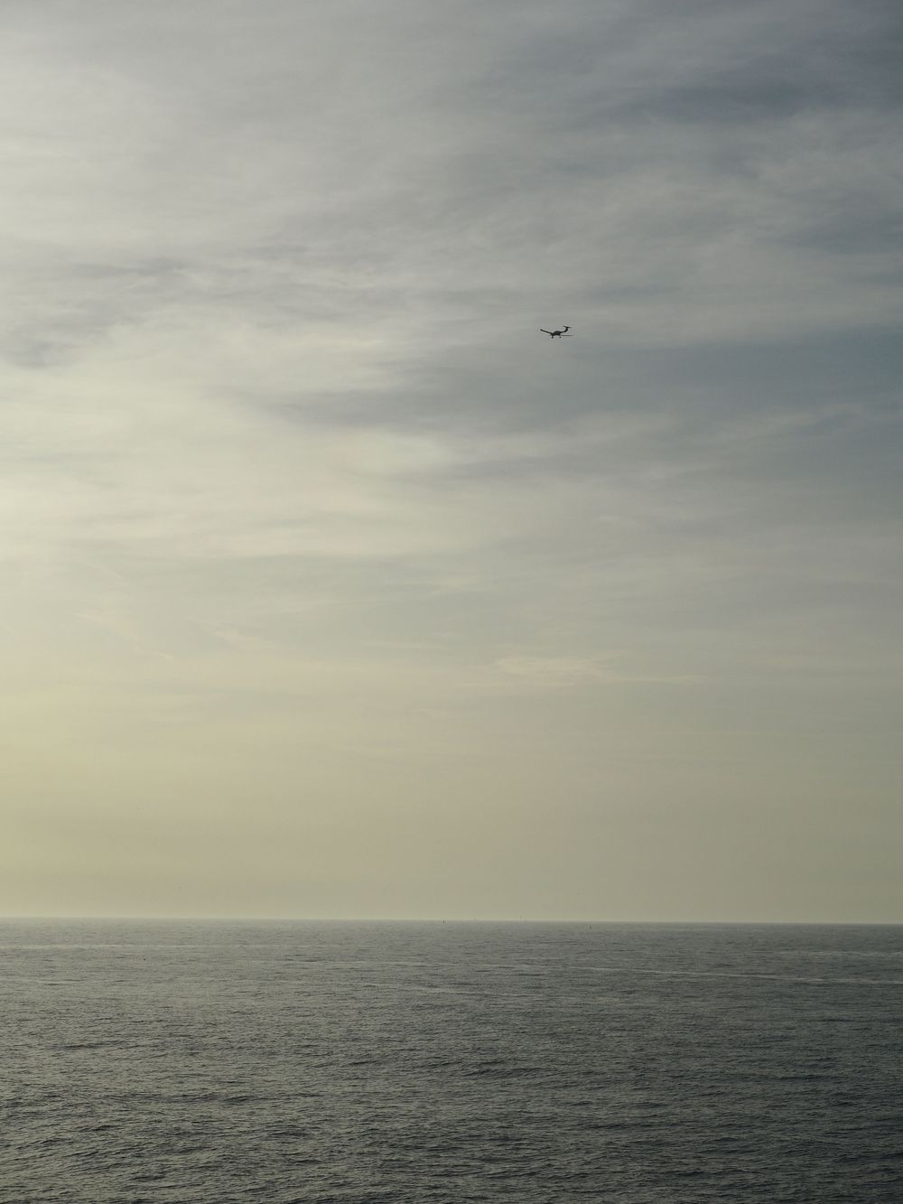 An airplane above the sea
