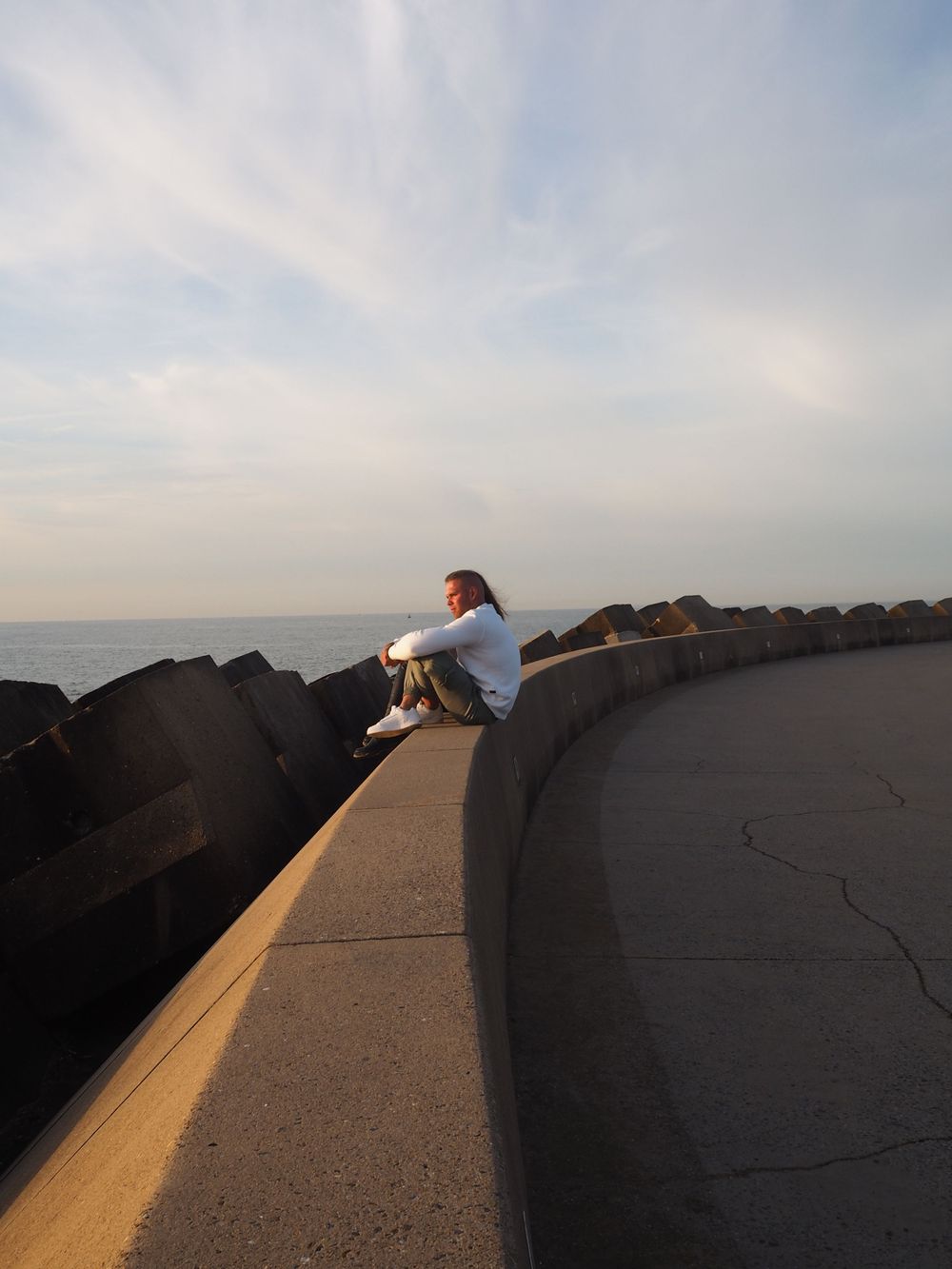 Two people watching the sunset on the pier