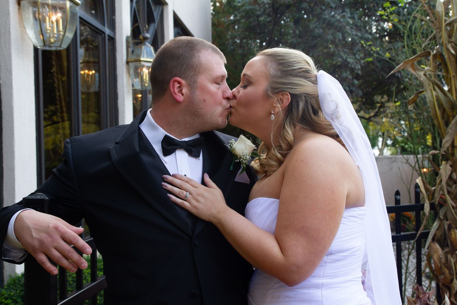 A romantic outdoor wedding photo sequence with white dress and black suit.