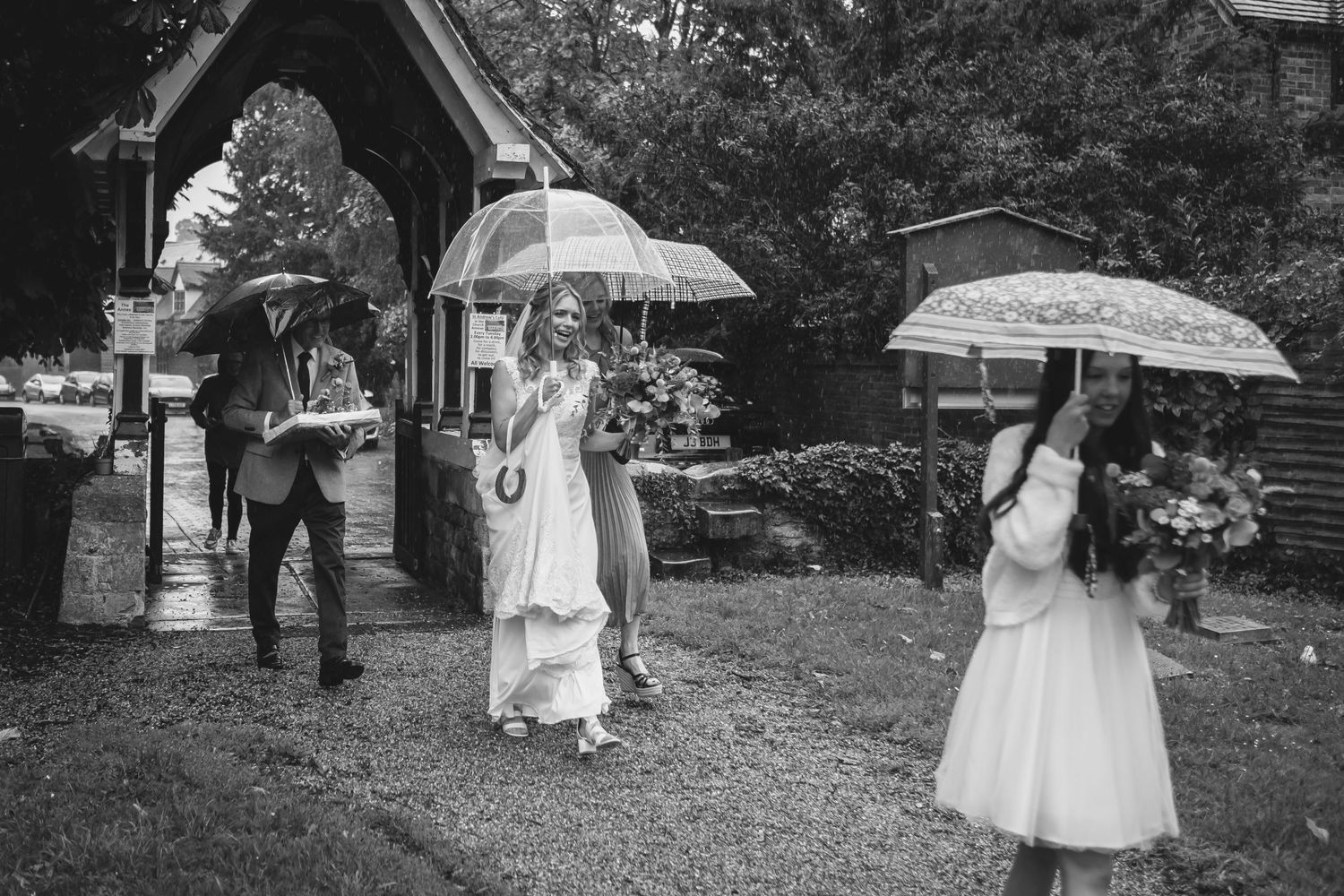 Bride walking to the church in the rain